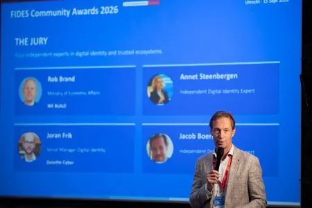 A speaker presenting the FIDES Community Awards 2026 slide that introduces the four independent jury members.